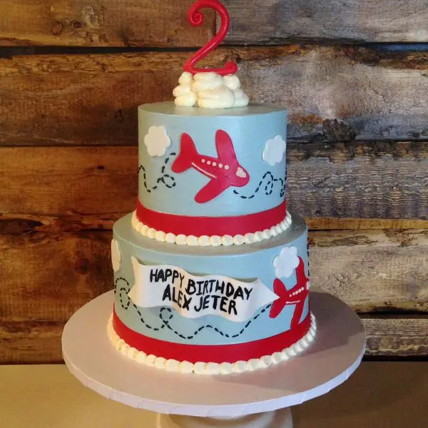 A two layer cake with airplanes on it