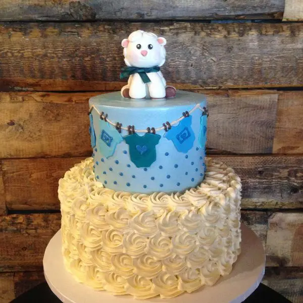 A cake with a baby theme on top of it.