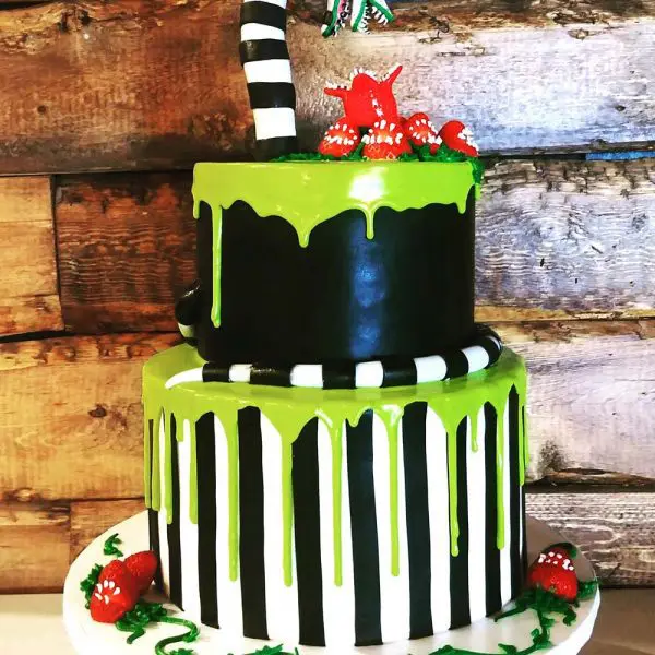 A two layer cake with green and black icing.