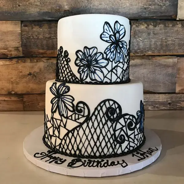 A two layer cake with black and white designs.