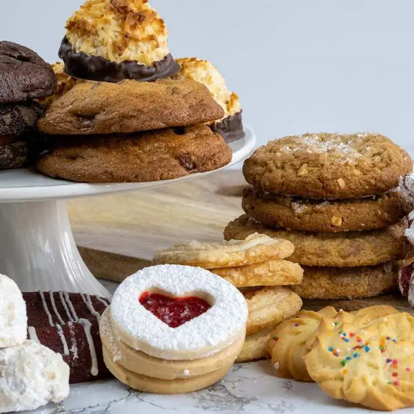 A table topped with lots of cookies and other desserts.