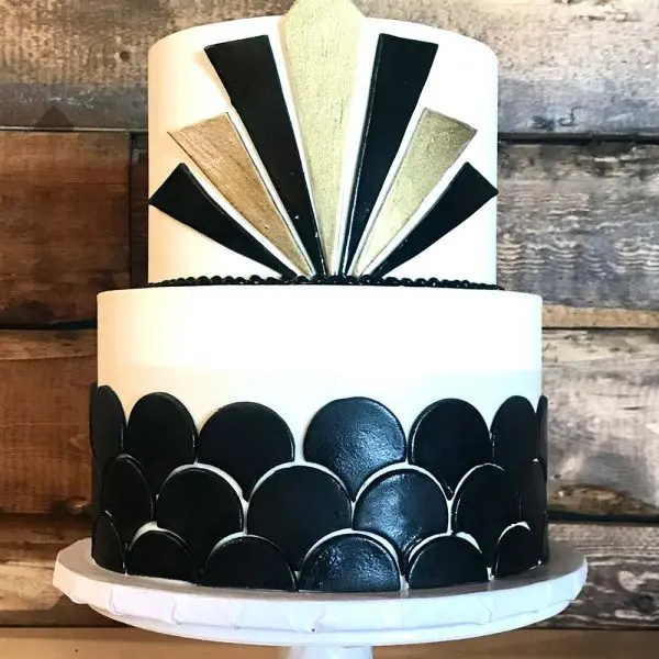 A cake with black and white decorations on top of it.