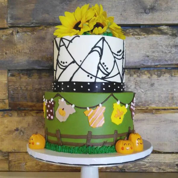 A cake with a yellow flower on top of it.