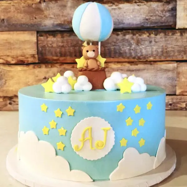 A cake with a teddy bear on top of it