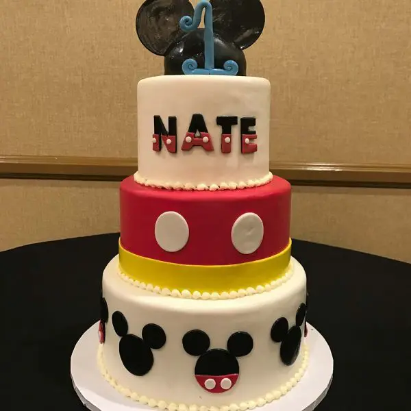 A mickey mouse themed birthday cake with name nate