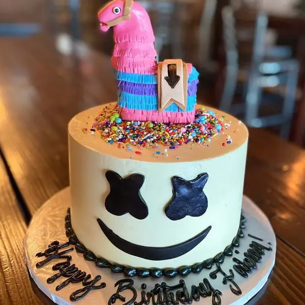 A birthday cake with a llama on top of it.