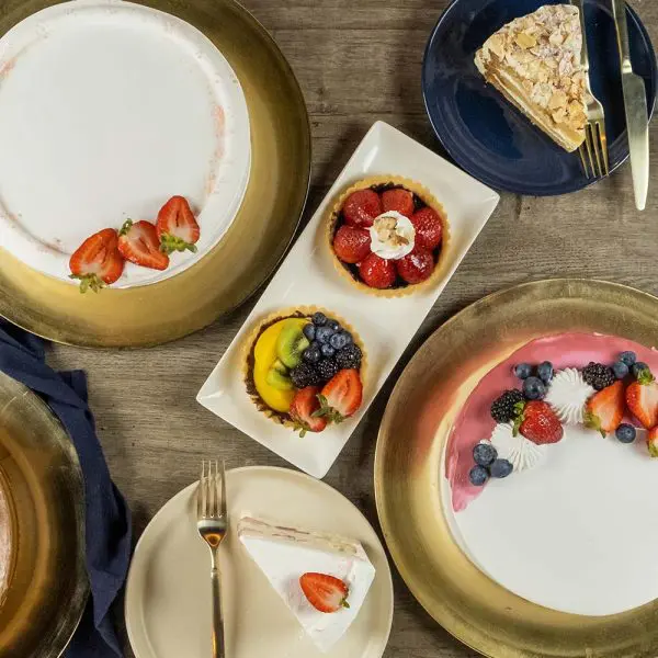 A table with plates and bowls of food on it