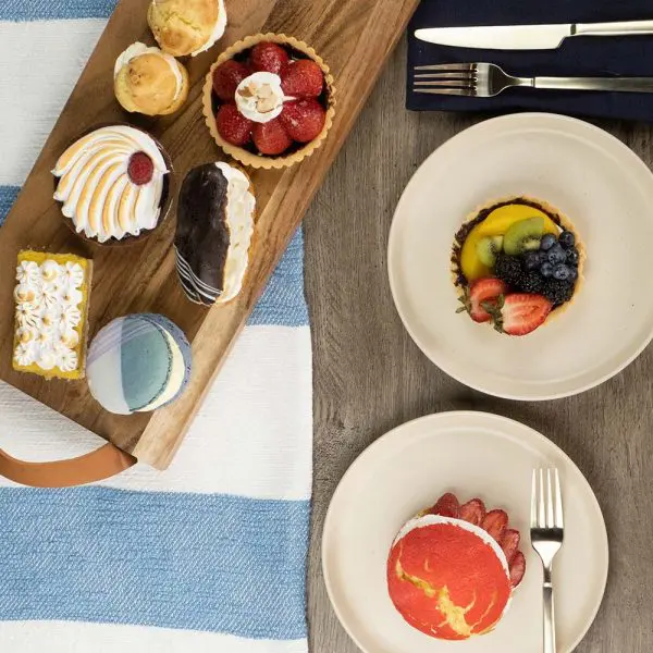 A wooden tray with some pastries on top of it