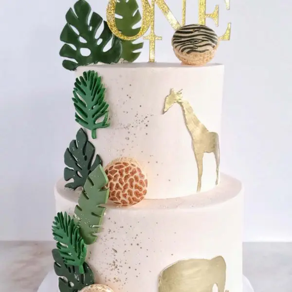 A cake with leaves and animals on it