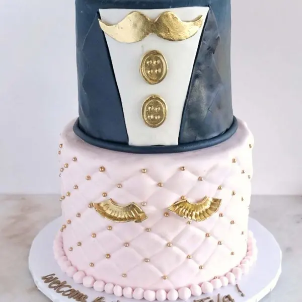 A cake with a suit and mustache on top of it.